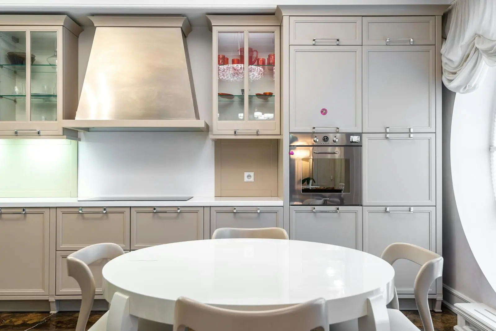 Fitted kitchen with a dining table and integrated oven and hob
