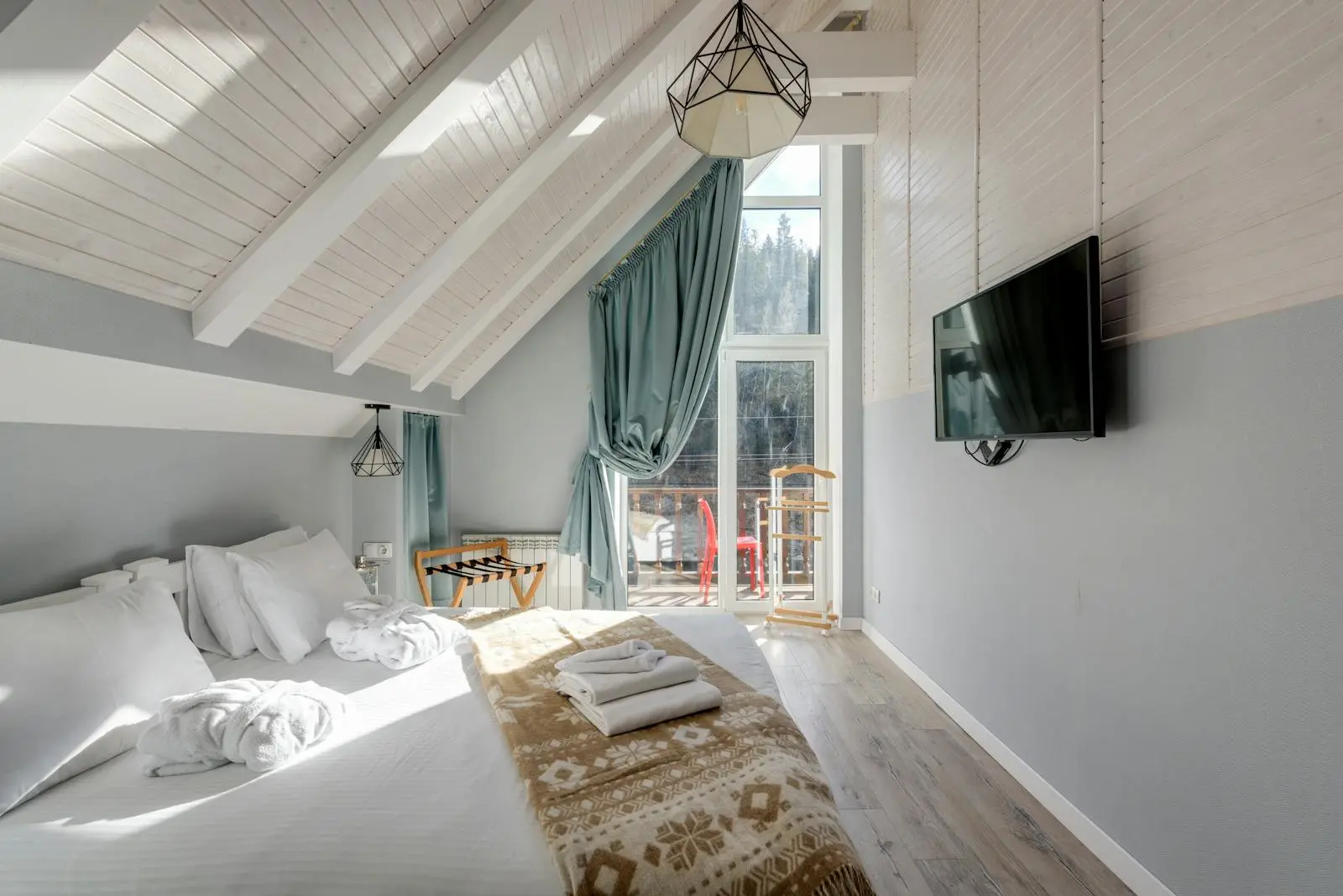 Converted loft bedroom with a vaulted beamed ceiling