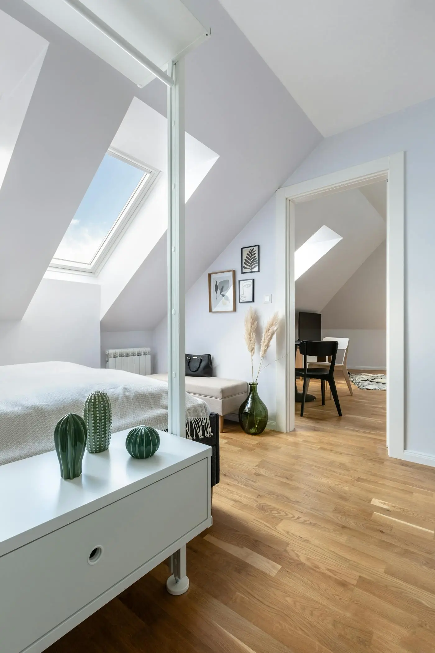 Loft conversion bedroom with sloped ceiling and a roof window