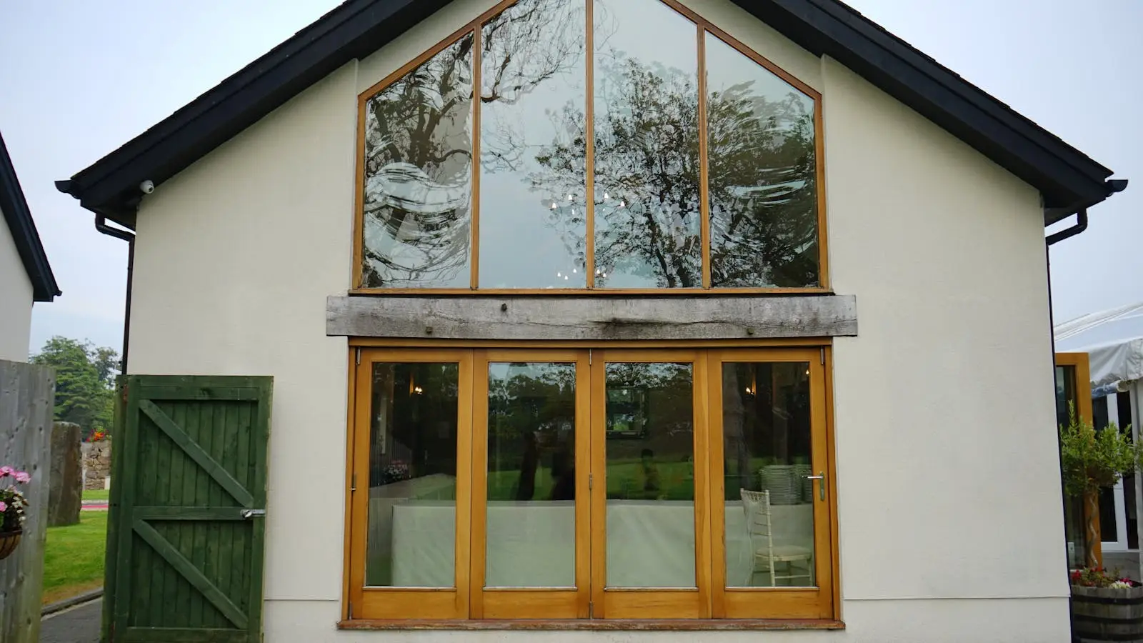 Rear house extension with a glazed apex gable and bi-fold doors